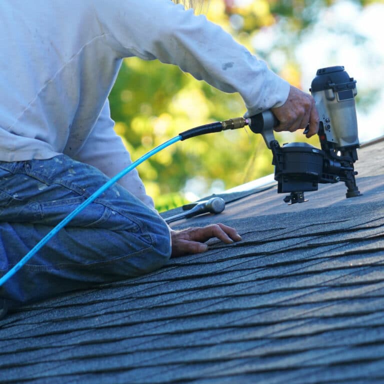 Roofers in Phoenix working on a shingle roof